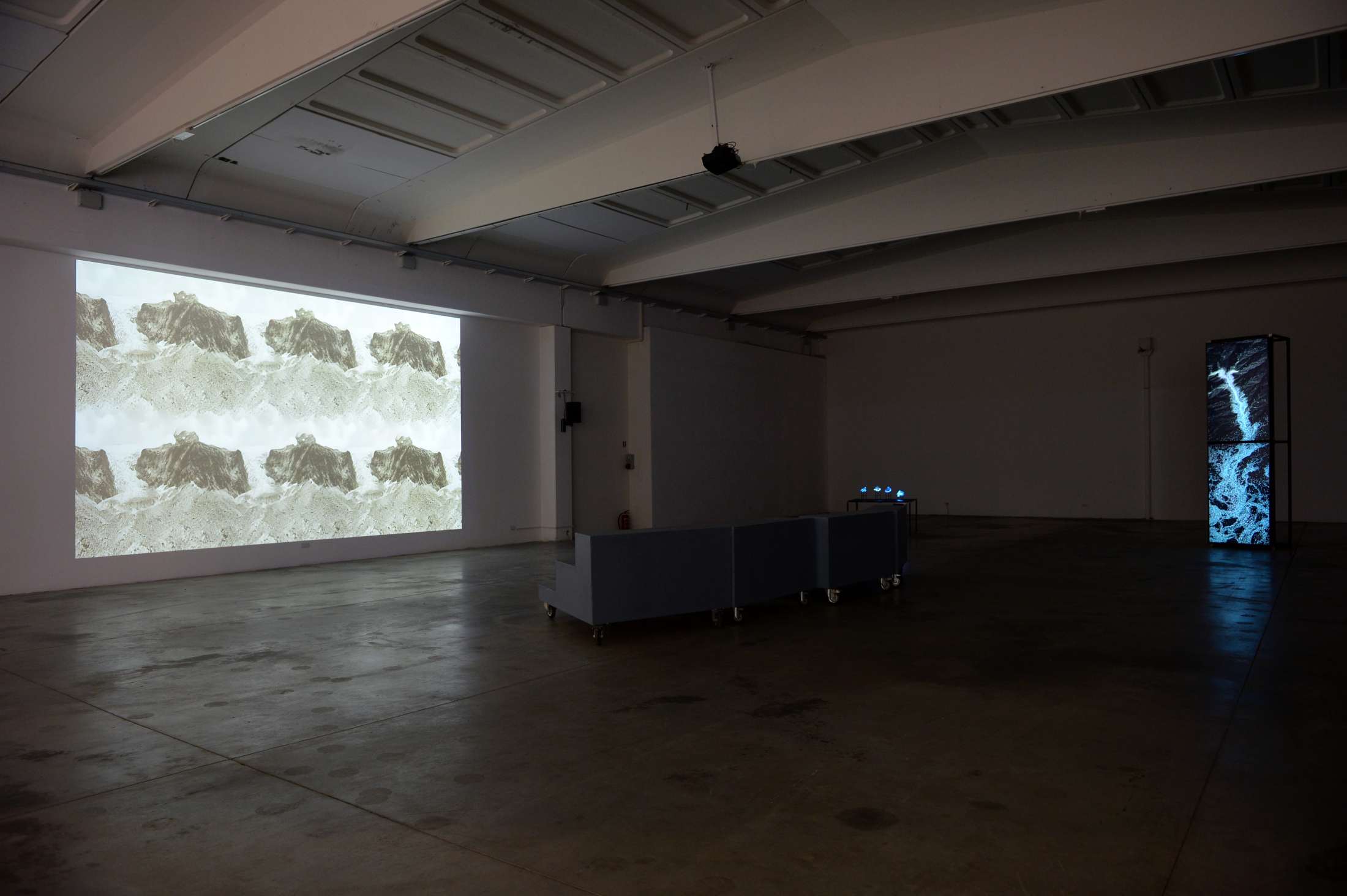 exhibition with video projection, glas sculptures and ai-generated videos on screen